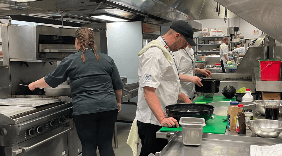 Photo of people cooking in Western Universities kitchen